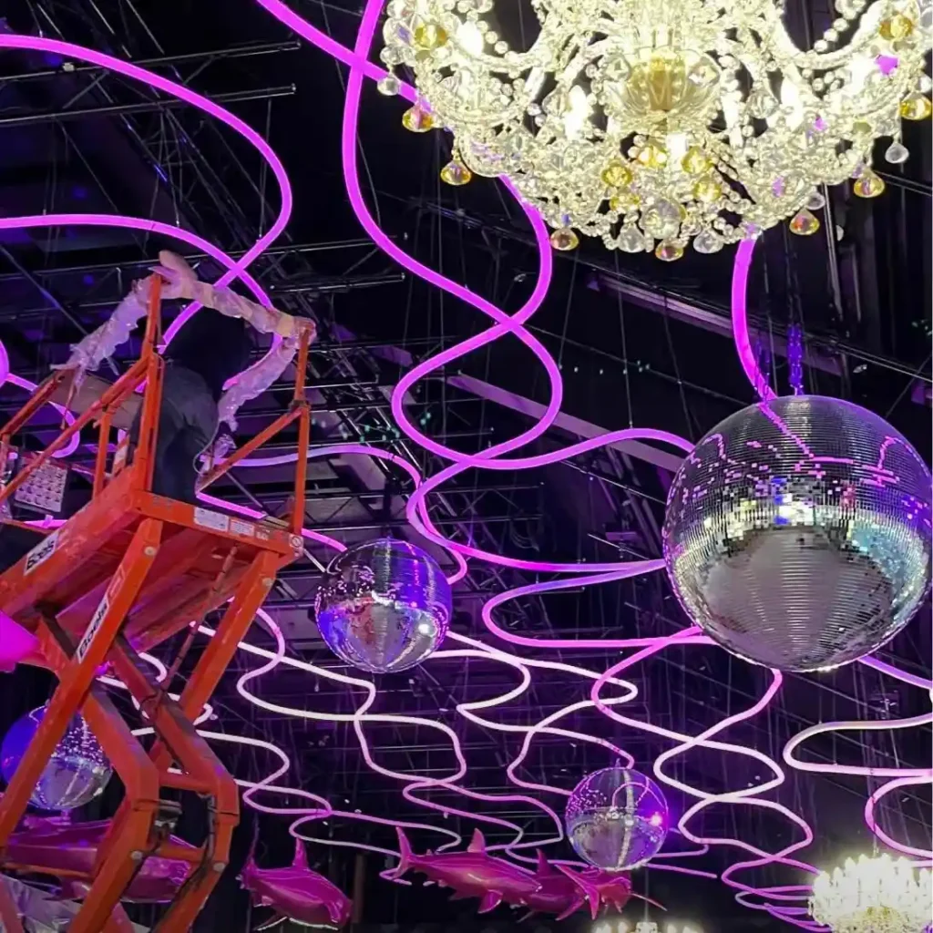 Pink RGB neon flex overhead canopy with addressable backbar wall in Prague immersive venue