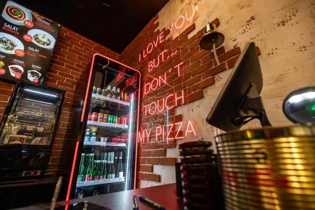 Neon flex LED PIZZA wordmark and order here arrow at Łódź food court counter