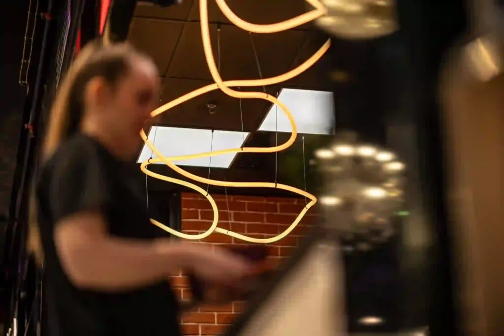 Neon flex LED PIZZA wordmark and order here arrow at Łódź food court counter