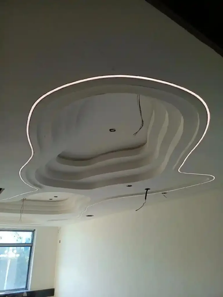 Linear LED lighting outlining a sculptural shell ceiling with recessed neon flex