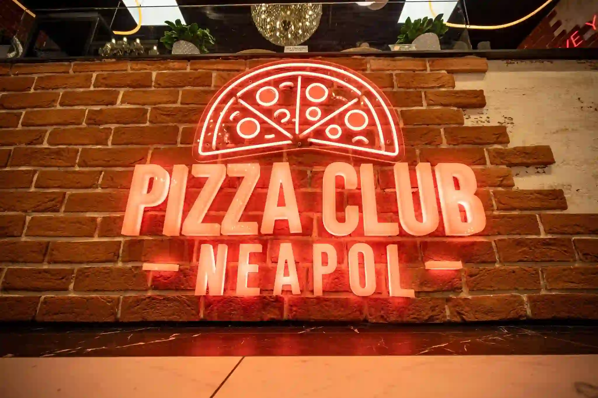 Coral red neon flex LED restaurant signage Pizza Club Neapol logo on brick wall