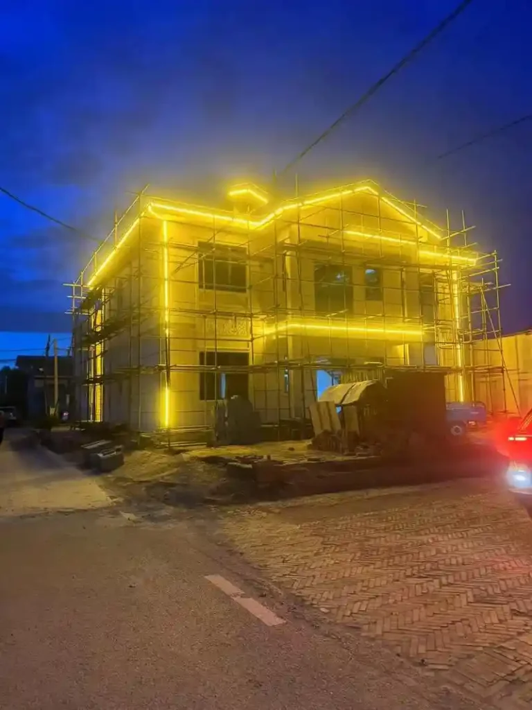 Aerial night view of outdoor neon flex outlining a Ganzhou village complex