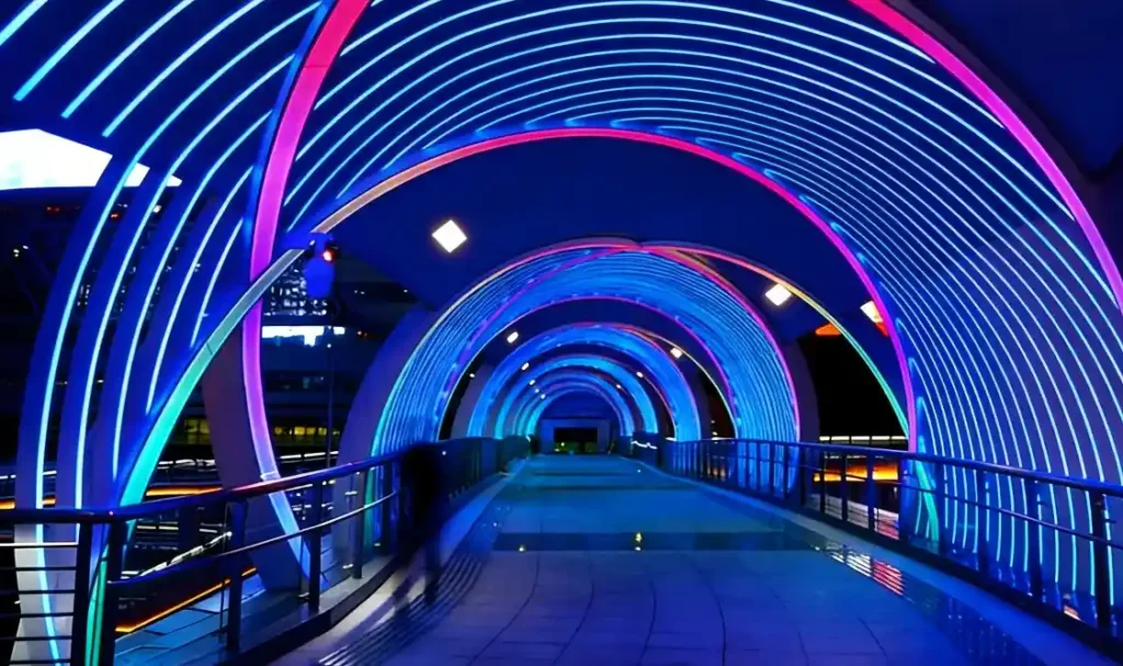 Pedestrian footbridge purple arch pixel mapping at Riyadh financial district