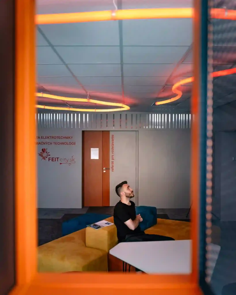 Sculptural amber round neon flex LED helix running along a Warsaw office corridor