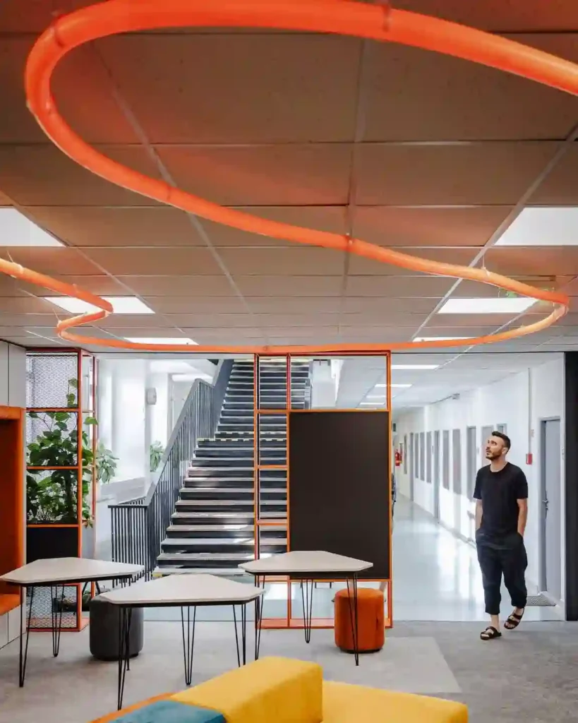 Round neon flex LED oval sculpture above creative office lounge in Warsaw