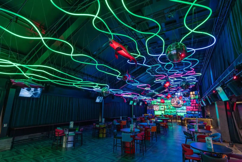 Bright RGB neon flex ceiling scene across Prague event hall main floor
